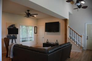 a living room with a couch and a flat screen tv at Lazy Lake Life Awaits! in Monticello