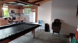 a kitchen with a table in the middle of a room at FINCA LA RAMONA in El Pomo