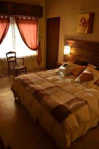 a bedroom with a large bed and a window at El Descanso in Funes +15 photos