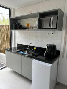 Kuchyň nebo kuchyňský kout v ubytování Flat com Piscina Privativa Tamandaré