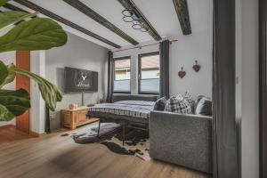 a room with a bed and a couch in it at HIRSCH Stadt Apartment 2 - Terrasse mit Flussblick - Parkplatz in Bad Harzburg