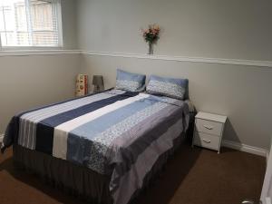 a bedroom with a bed and a vase of flowers at Cozy in London