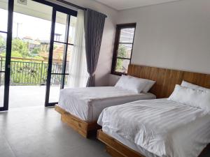 Sawitri Anandhita Luxury Villas客房内的一张或多张床位
