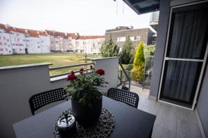 a balcony with a table with a potted plant on it at Apartment Sunshine in Čakovec