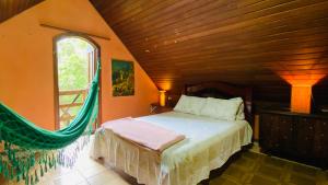 a bedroom with a bed in a room with a window at Casa de Campo - Condomínio Arco Íris in Atibaia