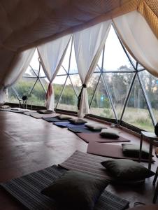 a room with a bunch of pillows on the floor at LA Viella Glamp Tala in Mar del Plata +33 photos