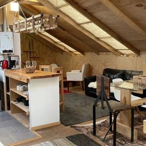 a kitchen and living room with a table and chairs at Refugio familiar con vista al mar in Ancud +10 photos