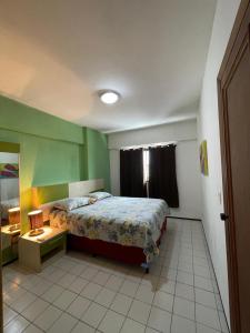 a bedroom with a bed and a table in it at Flat Mont Blanc - Perto de Tudo! in São Luís +11 photos