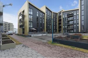 an empty street with tall buildings in a city at Premium apartment Queen downtown in Reykjavík