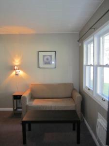 a living room with a couch and a table at Balm Beach Resort and Motel in Balm Beach