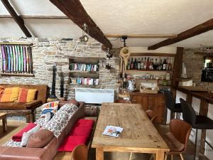 a living room with a couch and a wooden table at Family Holiday Home with Pool in Coray
