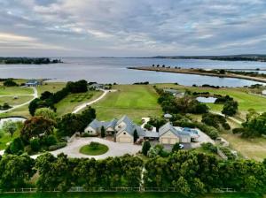 an aerial view of a house next to the water at Petite Chateau Waterfront chateau with Hot Tub in Clarence Point