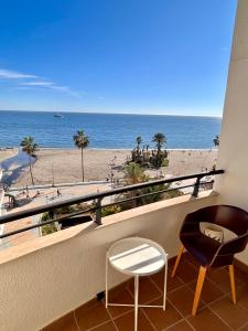 a balcony with two chairs and a view of the beach at Sinfonía Azul vistas al mar in Estepona