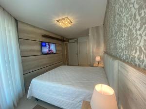 Postel nebo postele na pokoji v ubytování Residencial Celebretty 602 Capao da Canoa locação de temporada + 26 fotografií