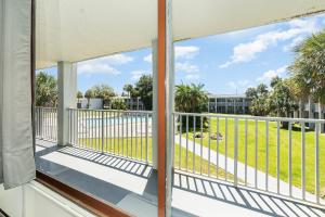 a balcony with a view of a park at Charming Suite: Smart TV, Modern Amenities & Pool Access in Kissimmee