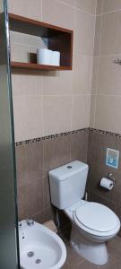 a bathroom with a toilet and a sink at Casas Catalina del Mar in Colonia Chapadmalal +15 photos