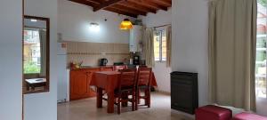 a kitchen with a table and chairs in a room at Casas Catalina del Mar in Colonia Chapadmalal