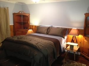 a bedroom with a bed and a table and a lamp at Near the Slopes - Big Bear Mountain getaway in Big Bear Lake