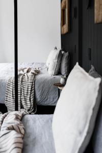 a bedroom with a bed and a couch at Love - Denmark WA in Denmark