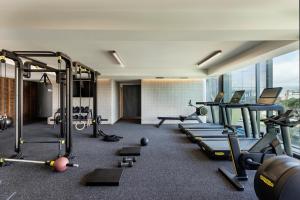 a gym with a lot of treadmills and machines at Pullman Auckland Airport in Auckland