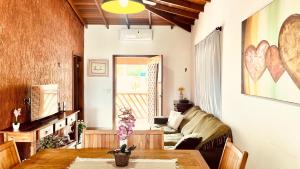 a living room with a couch and a table at Casa temporada Ilhabela in Ilhabela