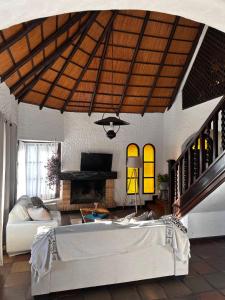 a living room with a couch and a fireplace at Chalet El Teson in Punta del Este