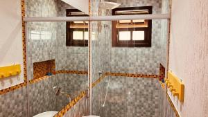 a bathroom with a glass shower and a sink at Casa temporada Ilhabela in Ilhabela +35 photos