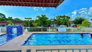 a swimming pool with blue water in a yard at Casaemcondomínio in Ananindeua