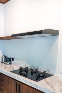 a kitchen with a black stove top in a kitchen at Raya Villa by Betterplace in Canggu +16 photos