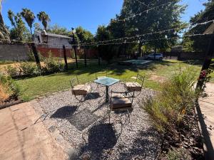 a patio with a table and chairs in a yard at La Estancia in Ybarlucea