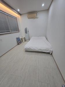 Postel nebo postele na pokoji v ubytování Daori Pension