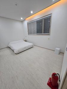 Postel nebo postele na pokoji v ubytování Daori Pension + 37 fotografií
