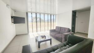 a living room with a couch and a coffee table at Hotel Quinta Avenida in Yopal