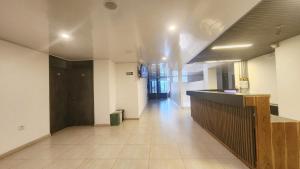 a hallway of an office building with a counter and a lobby at Hotel Quinta Avenida in Yopal