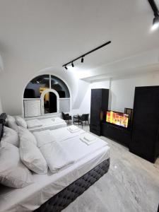 a bedroom with a large white bed in a room at Fine apartments Nis in Niš
