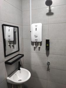 a bathroom with a sink and a mirror at Air Putih Homestay 23 in Kuantan