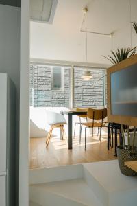 a dining room and living room with a table and chairs at Tokyo Cabin in Musashino
