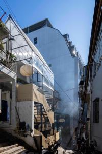 a glass facade of a building with a staircase at The Lamp Boutique House in Da Lat