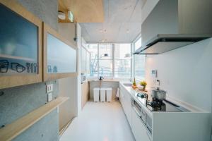 a kitchen with white counters and a stove top oven at Tokyo Cabin in Musashino +85 photos