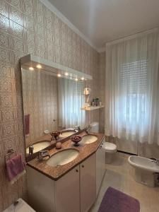 a bathroom with a sink and a toilet and a mirror at Luxury House San Felice in Bologna +19 photos