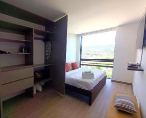 a bedroom with a bed and a large window at AH/Loft Tecnología Alexa, Coworking, Parking, Chía in El Cerrito +35 photos