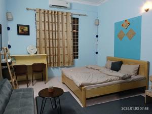a bedroom with a bed and a couch at Cactus Homestay 2 in Hanoi