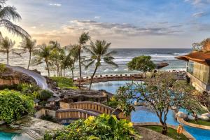 a resort with a swimming pool and the ocean at Hilton Bali Resort in Nusa Dua