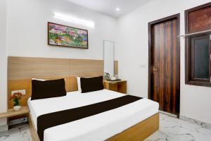 Postel nebo postele na pokoji v ubytování Hotel O ASP Royal Residency