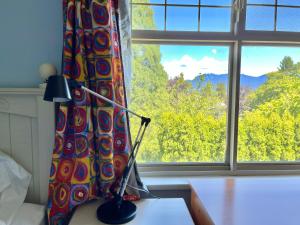 a lamp sitting on a table in front of a window at Cozy Guest Rooms Near UBC, Downtown and Beaches in Vancouver