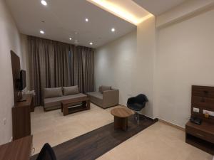 a living room with a couch and a table at Neelam Orchid in Kānpur