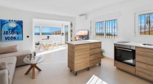 a living room with a couch and a table at Penthouse - Beach - Sea View - Pool - 40 sqm Private Terrace - One Bedroom - Sleeping Alcove in Benalmádena