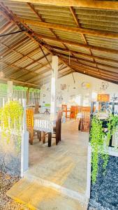 a room with a table and chairs and a ceiling at Suriya Cottage Family Resort in Habarana