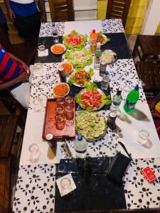 a long table with many plates of food on it at Suriya Cottage Family Resort in Habarana