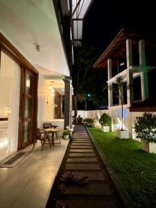 a backyard of a house at night with a table at Madiha Venus in Matara